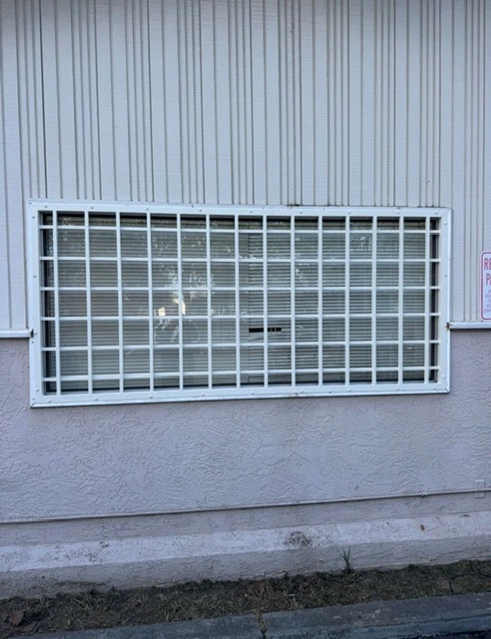 White security bars fitted to a storefront door and windows